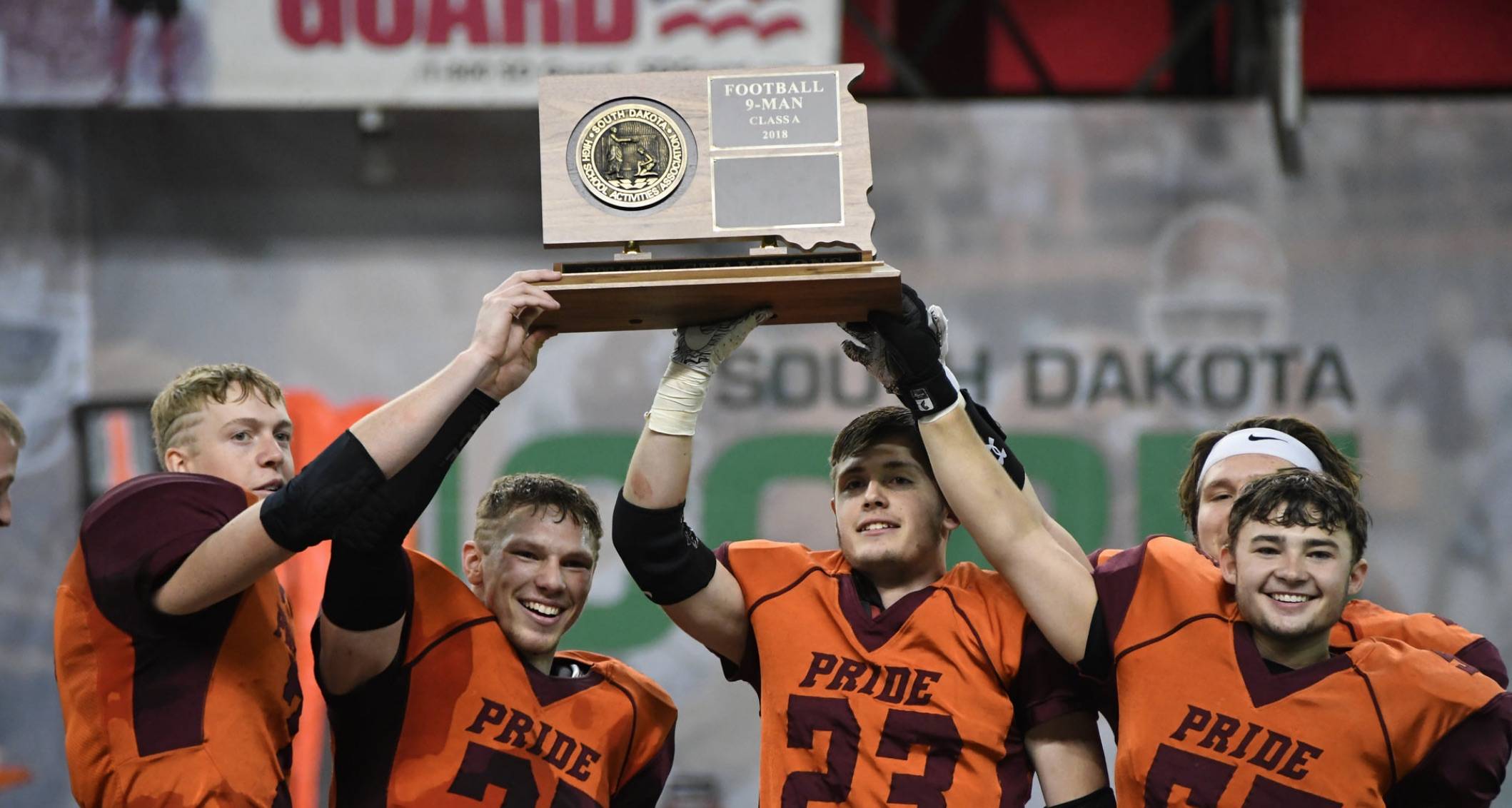 HS football players holding state title