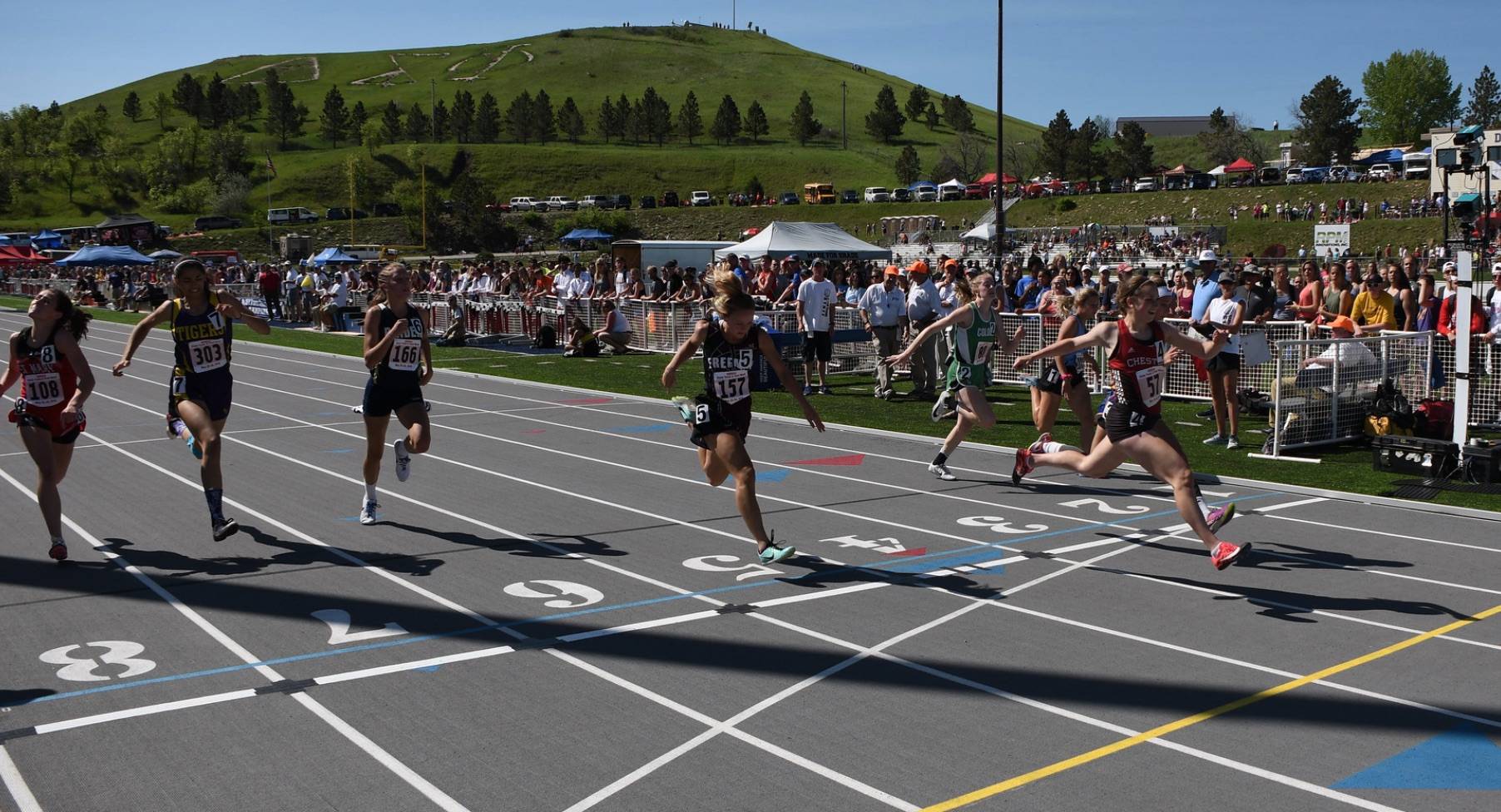 Track runners crossing the finish line