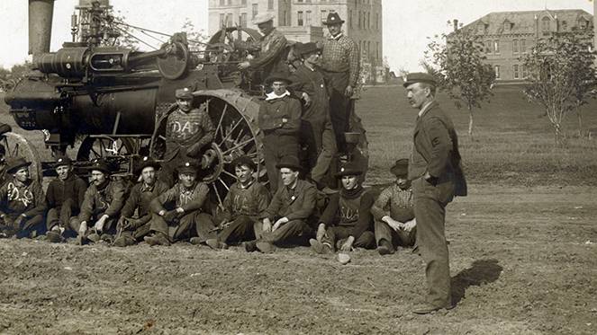 Halvor Solberg standing with students at South Dakota College of Agriculture and Mechanic Arts