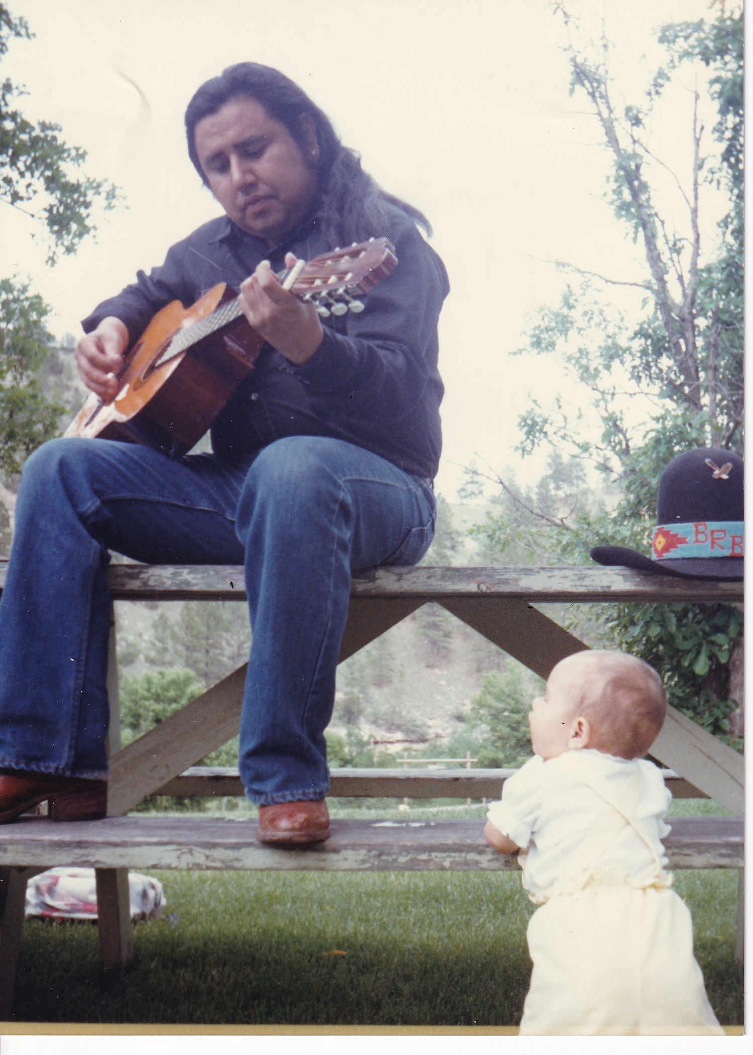 Image - buddy playing guitar with stardust picnic bench.jpg