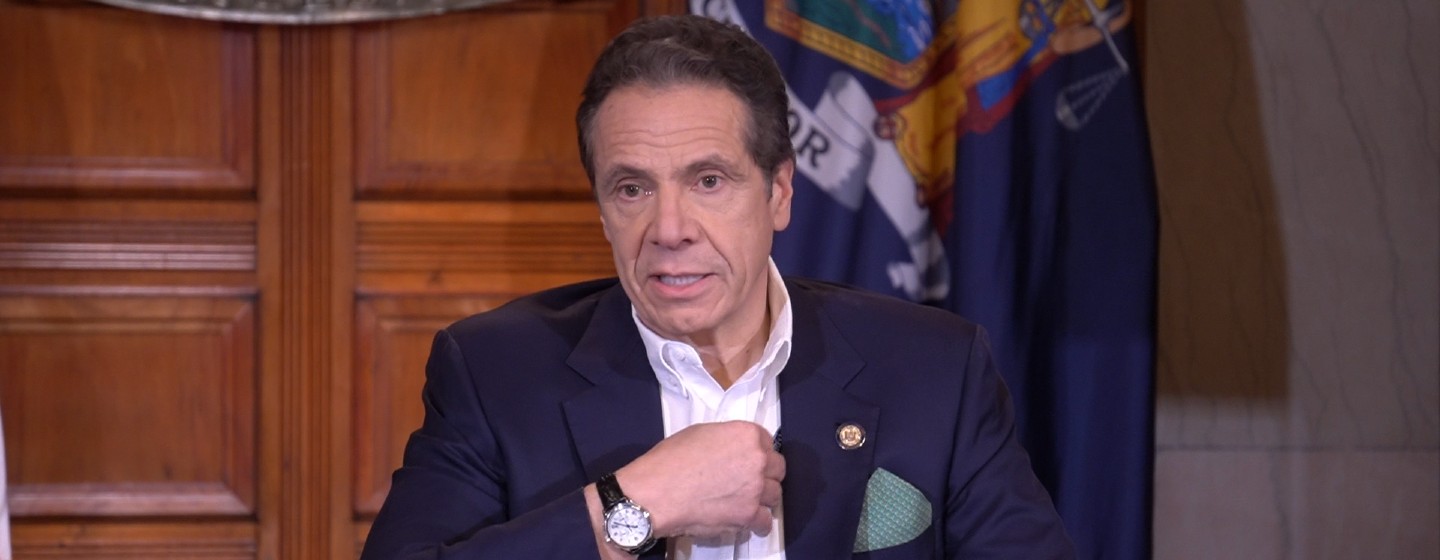 Governor Cuomo sits and addresses the press' questions during a press briefing