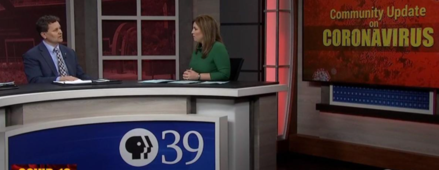 TV news anchor interviews a guest