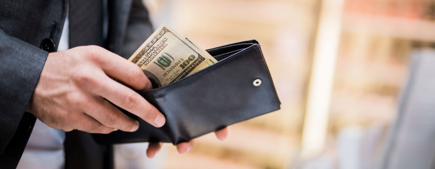 Man pulls money out of a wallet