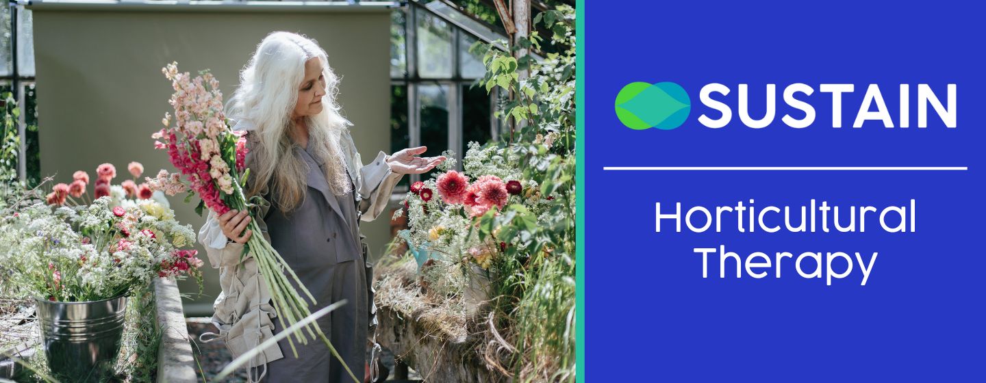 Woman tending to plants and flowers in a greenhouse