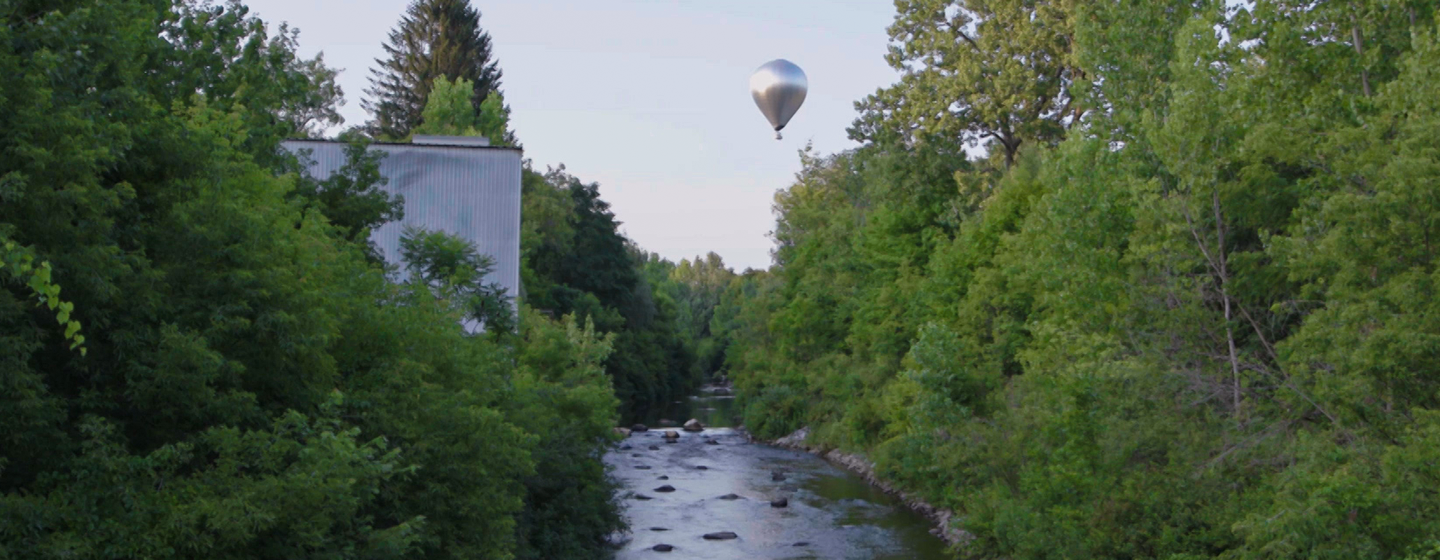 The New Horizon mobile art project flies over a creek in Massachusetts.